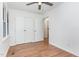 Bright bedroom with hardwood floors, ceiling fan, and closet at 828 Cotton Pl, Raleigh, NC 27601