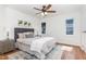 Bright bedroom with neutral decor, ceiling fan, and a large window overlooking the backyard at 828 Cotton Pl, Raleigh, NC 27601