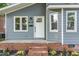 A close-up of the front door with brick steps and manicured landscaping with flowers at 828 Cotton Pl, Raleigh, NC 27601