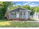 Charming gray home featuring a welcoming front porch and well-maintained lawn at 828 Cotton Pl, Raleigh, NC 27601