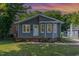 Charming home featuring a well-maintained lawn, gray siding, and a welcoming front porch at 828 Cotton Pl, Raleigh, NC 27601