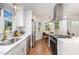 Bright kitchen with stainless appliances, white cabinets, countertops, and eat-in breakfast nook with backyard view at 828 Cotton Pl, Raleigh, NC 27601