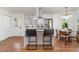 Modern kitchen featuring white cabinets, stainless steel appliances, and a stylish dining area at 828 Cotton Pl, Raleigh, NC 27601