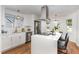 Bright kitchen with an island, white cabinetry, stainless steel appliances, and a view of the outside at 828 Cotton Pl, Raleigh, NC 27601