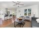 Spacious living room showcasing an open floor plan, hardwood floors, and barstool seating at a kitchen island at 828 Cotton Pl, Raleigh, NC 27601