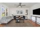 Cozy living room featuring hardwood floors, a gray sofa, and contemporary decor at 828 Cotton Pl, Raleigh, NC 27601