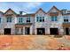 New townhomes under construction featuring covered garages, craftsman windows and modern architectural design at 87 Ripple Way # 214, Clayton, NC 27520
