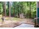 Secluded backyard with lush trees, shed, patio, and space for entertaining at 90 Oak Leaf Ln, Chapel Hill, NC 27516