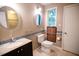 Bright bathroom featuring double mirrors, dark vanity, and accessibility bars for added convenience at 90 Oak Leaf Ln, Chapel Hill, NC 27516