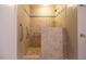 Accessible tiled shower featuring a rain shower head, grab bars, and a convenient built-in seat at 90 Oak Leaf Ln, Chapel Hill, NC 27516