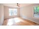 Spacious bedroom with hardwood floors, ample natural light, and modern ceiling fan at 90 Oak Leaf Ln, Chapel Hill, NC 27516