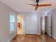 Inviting bedroom with ceiling fan, hardwood floors, and access to bathroom and hallway at 90 Oak Leaf Ln, Chapel Hill, NC 27516