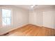 Bright bedroom with hardwood floors, two closets, and a window offering ample natural light at 90 Oak Leaf Ln, Chapel Hill, NC 27516
