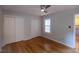 Bright bedroom featuring two closets, hardwood floors, and a window that provides plenty of sunlight at 90 Oak Leaf Ln, Chapel Hill, NC 27516