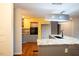 Bright, spacious kitchen with grey cabinets, stainless appliances, and wood flooring at 90 Oak Leaf Ln, Chapel Hill, NC 27516