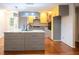 Island with granite countertop, stainless steel appliances, and yellow cabinetry at 90 Oak Leaf Ln, Chapel Hill, NC 27516