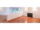 Cozy living room showcasing hardwood floors, a stylish fireplace, and a serene view of the outdoors at 90 Oak Leaf Ln, Chapel Hill, NC 27516