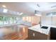 Open concept living room with hardwood floors, recessed lighting, and bright, airy windows at 90 Oak Leaf Ln, Chapel Hill, NC 27516
