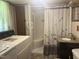 Bathroom with shower stall, granite-style sink, and laundry machines for convenience at 912 E Pope St, Dunn, NC 28334