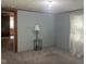 Image of a bedroom featuring neutral carpet, a side table with lamp, and light-blocking curtains at 912 E Pope St, Dunn, NC 28334