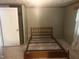 Bedroom with neutral carpet, a bed frame, and a door leading to additional rooms at 912 E Pope St, Dunn, NC 28334