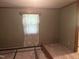 Image of a bedroom featuring neutral carpet, vintage curtains, and space for a bed frame at 912 E Pope St, Dunn, NC 28334