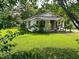 Charming one-story home surrounded by a lush green lawn and mature trees, offering a peaceful setting at 912 E Pope St, Dunn, NC 28334