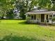 A quaint one-story home with a large, green front lawn, perfect for outdoor activities and relaxation at 912 E Pope St, Dunn, NC 28334
