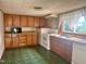 Functional kitchen with wooden cabinets, a stainless steel sink, and updated appliances, ready for cooking at 912 E Pope St, Dunn, NC 28334