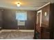 A cozy living room with wood-paneled walls and a decorative fireplace at 912 E Pope St, Dunn, NC 28334