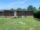 Backyard view of a brick home with a well-manicured lawn, offering a private outdoor space at 916 Waring St, Durham, NC 27704
