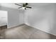 Spacious bedroom featuring a ceiling fan and neutral carpet complemented by fresh white walls at 916 Waring St, Durham, NC 27704