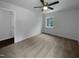 Bright bedroom featuring a ceiling fan, neutral carpet, and a large window for plenty of light at 916 Waring St, Durham, NC 27704