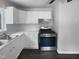 Modern kitchen with new stainless steel range and appliances, featuring ample counter space at 916 Waring St, Durham, NC 27704