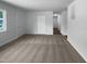 Open-concept living room with neutral carpet and fresh white walls with outside views at 916 Waring St, Durham, NC 27704