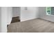 Inviting living room featuring neutral carpet, fresh white walls, and views into adjoining rooms at 916 Waring St, Durham, NC 27704
