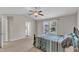 Bright bedroom features a window, fan, and adjoining bathroom at 960 Sandyhill Rd, Wendell, NC 27591