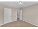 Cozy bedroom with plush neutral carpet, light color walls, and two closets with doors at 960 Sandyhill Rd, Wendell, NC 27591