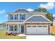 Beautiful two-story home with stone accents, blue shutters and a two-car garage at 960 Sandyhill Rd, Wendell, NC 27591