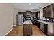 Modern kitchen with stainless steel appliances, dark wood cabinets, and a center island at 960 Sandyhill Rd, Wendell, NC 27591