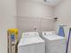 Bright laundry room featuring modern washer, dryer, wire rack, and neutral wall color at 960 Sandyhill Rd, Wendell, NC 27591