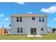 Two-story home featuring a sliding glass door leading to the backyard and a concrete patio at 960 Sandyhill Rd, Wendell, NC 27591