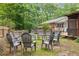 Scenic backyard featuring a circular seating area and lush greenery at 9801 Honeycutt Rd, Raleigh, NC 27614