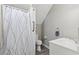 Compact bathroom featuring a shower, toilet, and sink, providing essential amenities in a functional layout at 9801 Honeycutt Rd, Raleigh, NC 27614
