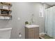Updated bathroom featuring a modern vanity, decorative shelves, and stylish fixtures at 9801 Honeycutt Rd, Raleigh, NC 27614