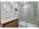 Renovated bathroom features a modern vanity, glass-enclosed shower, and updated fixtures at 9801 Honeycutt Rd, Raleigh, NC 27614