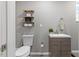 Updated bathroom featuring a modern vanity, decorative shelves, and stylish fixtures at 9801 Honeycutt Rd, Raleigh, NC 27614