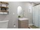 Updated bathroom featuring a modern vanity, decorative shelves, and stylish fixtures at 9801 Honeycutt Rd, Raleigh, NC 27614