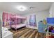 Bedroom featuring custom cabinets, modern light fixture, and wood-look flooring at 9801 Honeycutt Rd, Raleigh, NC 27614