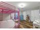 Bedroom featuring custom cabinets, modern light fixture, and wood-look flooring at 9801 Honeycutt Rd, Raleigh, NC 27614